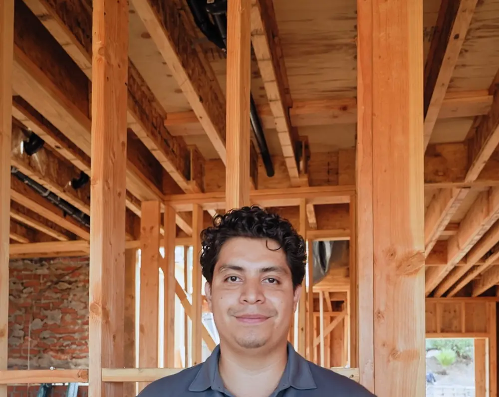 Ricardo of VR Plumbing Inc and Construction standing inside a house he is framing